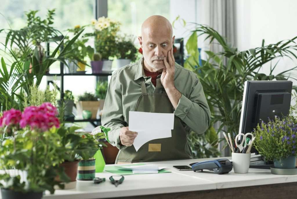 Business owner checking expensive bills