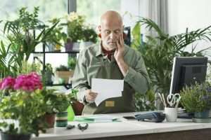 Business owner checking expensive bills