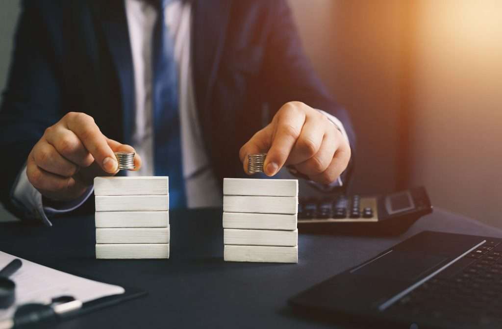 Businessman separates wooden block. Concept of wealth equality. Division of property. Divorce and le
