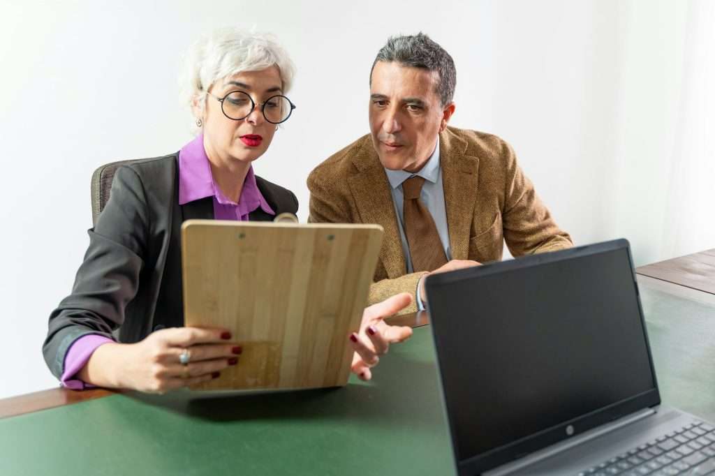 Consultant and Client Reviewing Contract - Detailed Verification