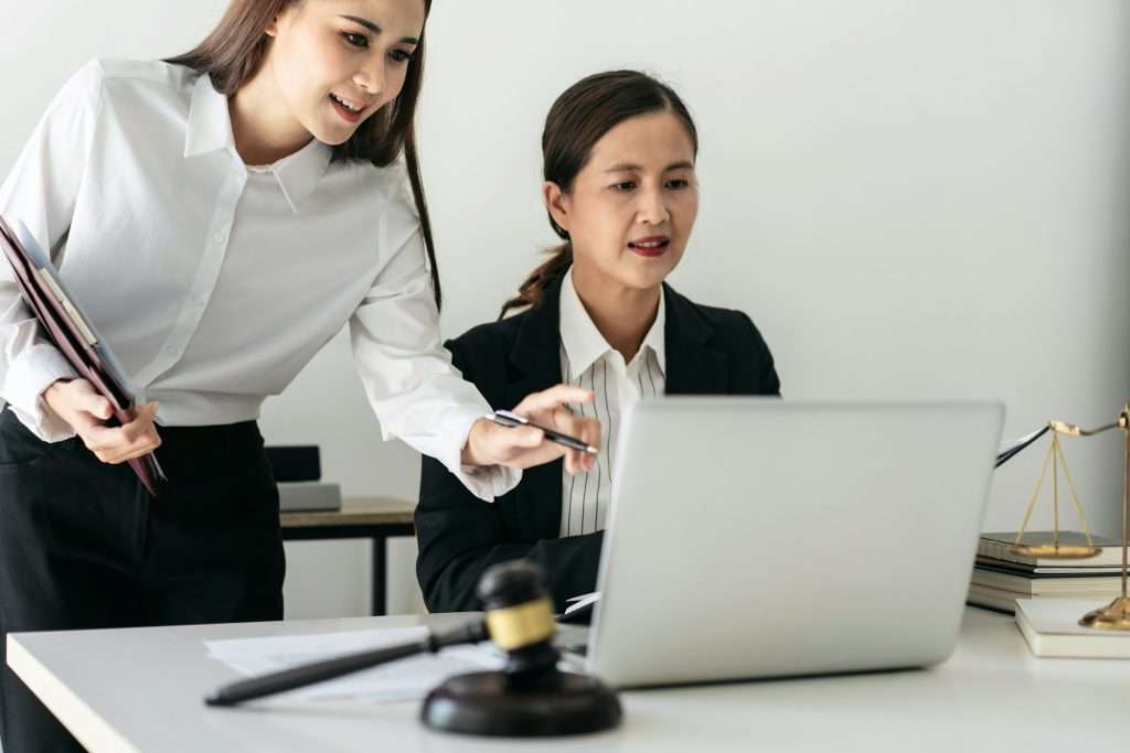 Female lawyer is holding law book and giving advice about laws a