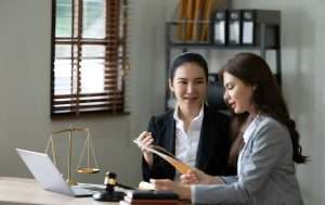 Female Lawyer Litigation Trial Lawyer office. Statue of Justice with scales and lawyer working on a