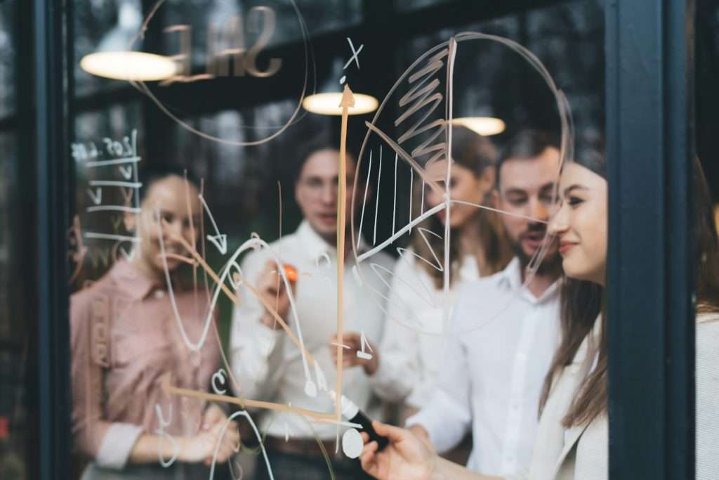 Group of coworkers discussing sale strategy in conference room