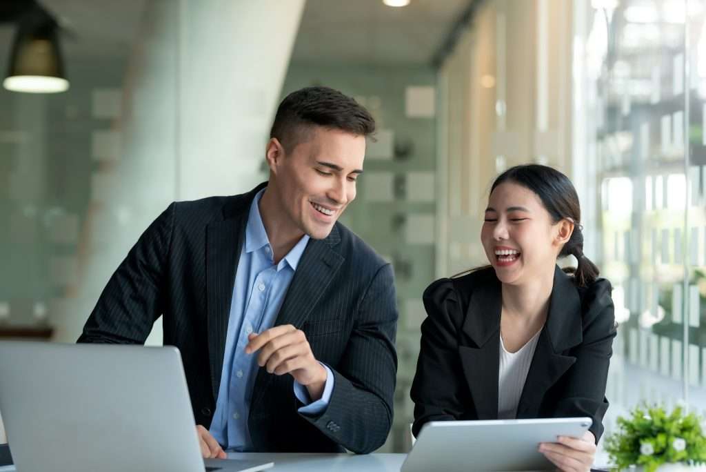 Happy two business people discuss investment project working and planning strategy. Businessman and