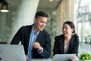 Happy two business people discuss investment project working and planning strategy. Businessman and