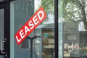 Leased sign on window of a cafe. Rental commercial property .