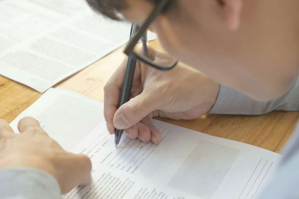 Man write in application form