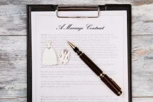 Marriage contract and pen top view.