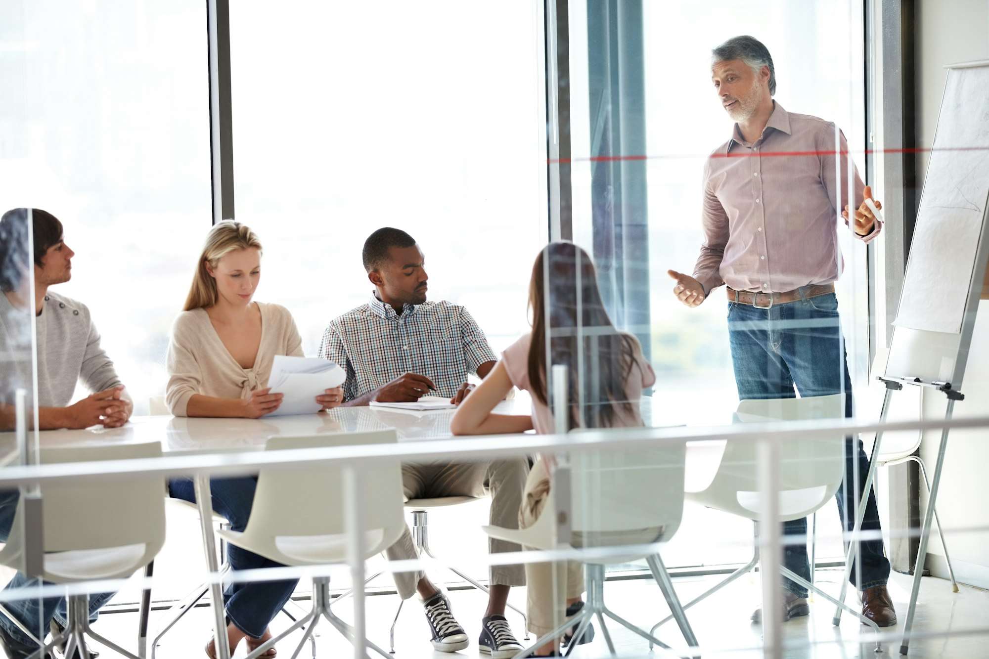 The AGM - Shareholders. A group of businesspeople sitting in a meeting.