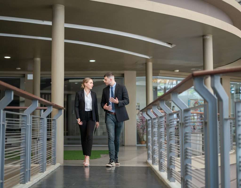 The lifestyle of young businessmen walking and chatting in a large office.
