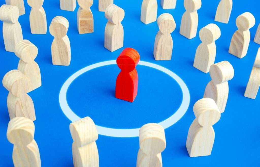 The red man keeps his distance in people crowd. Personal space, comfort zone. Protection of physical