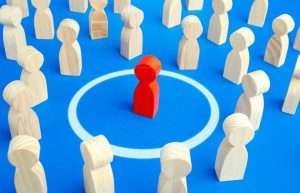 The red man keeps his distance in people crowd. Personal space, comfort zone. Protection of physical