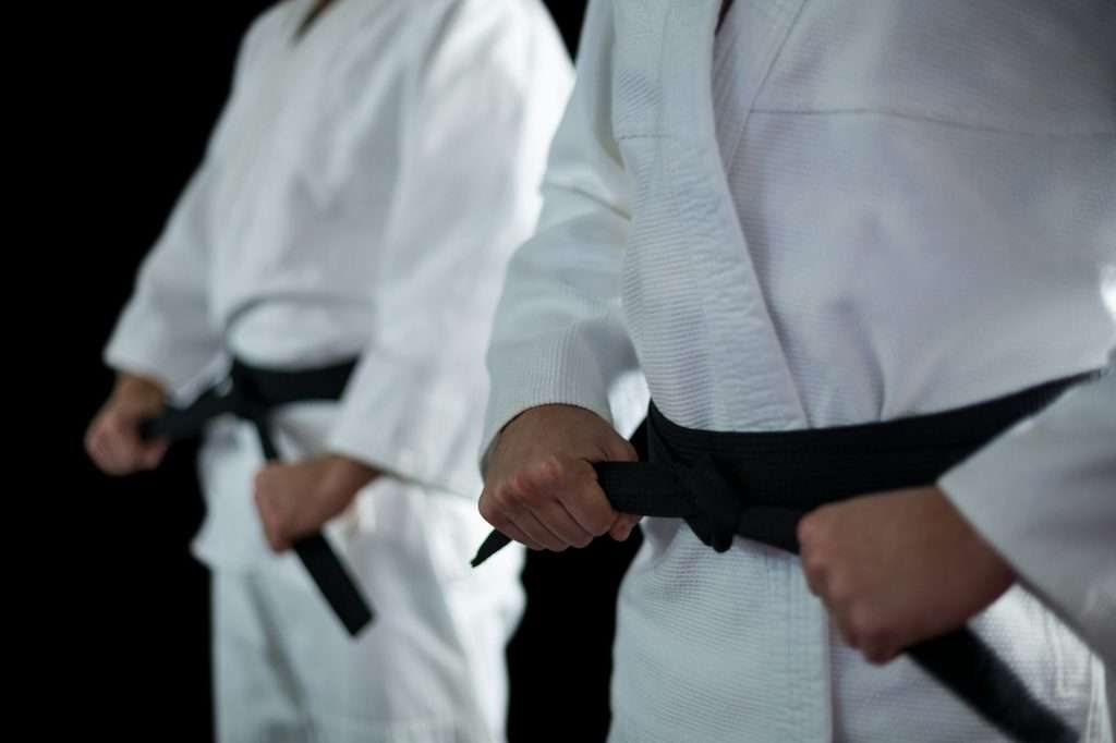 People in karate uniforms in a defensive stance representing the legal defences available in a defamation action