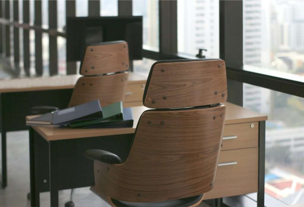 wooden table desk in office business room with big windows background