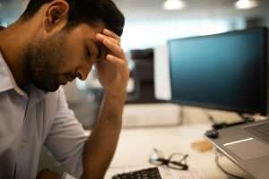 Worried businessman sitting in office