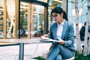 Young woman in office suit with paperwork