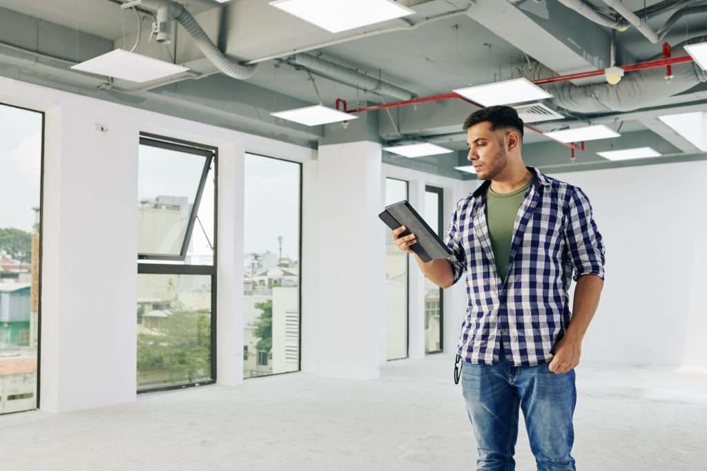 Contractor reading report on tablet
