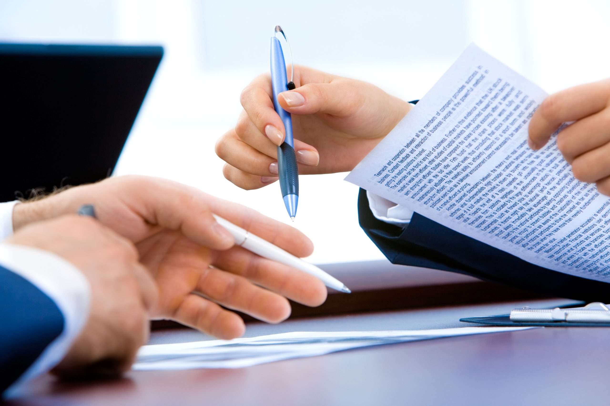Two people signing a contract representing the legal remedies available for breach of contract in Canadian law