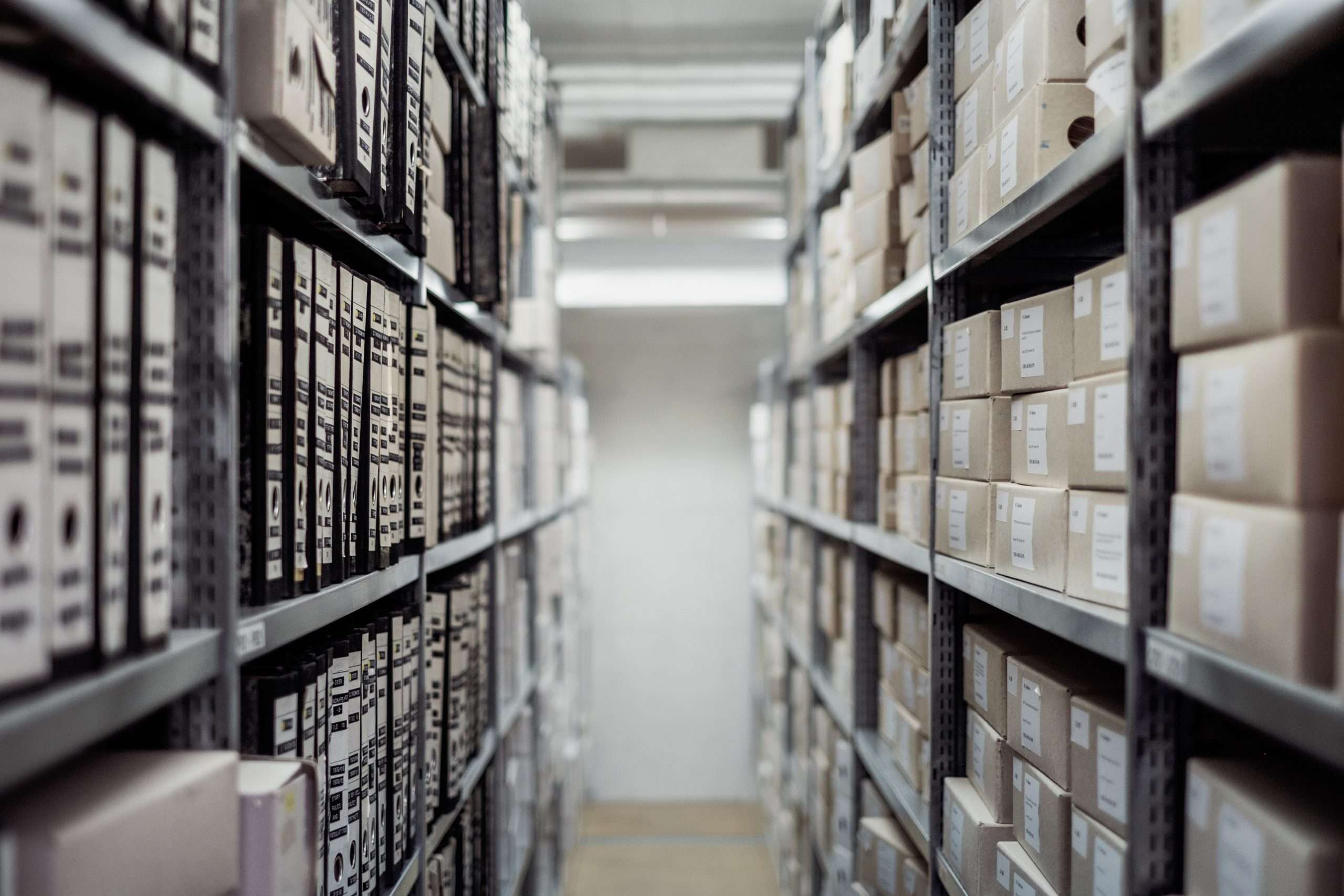 Rows of bankers boxes on shelves representing third-party document disclosure in a Norwich Order application