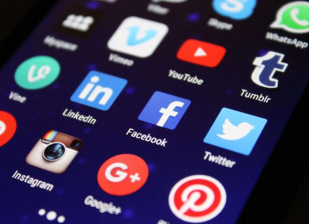 Screen displaying social media platform icons representing online platform liability for defamatory reviews in Canadian law