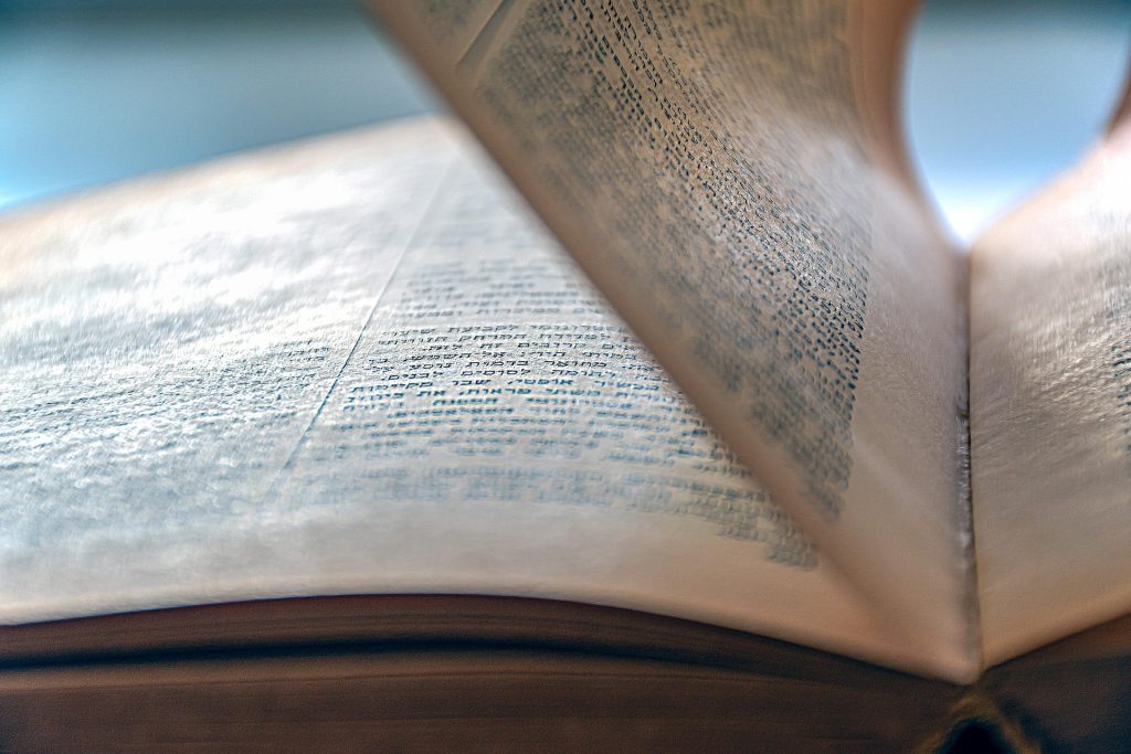 An old book being opened, representing the centuries-old common law tradition that gave rise to the modern Canadian law of express, resulting, and constructive trusts
