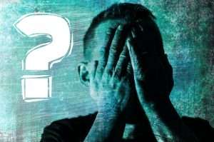 Man doing a facepalm next to a question mark representing the legal consequences of mistakes in contracting under Canadian law