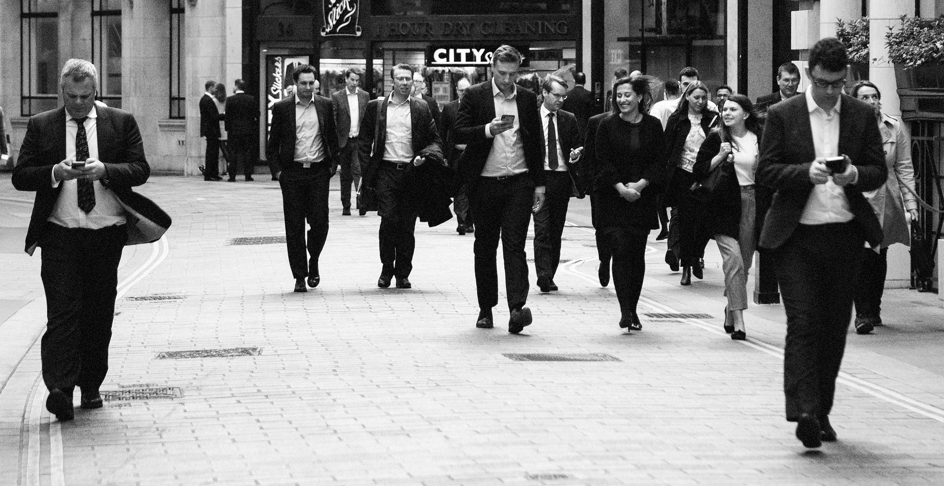 A black and white image of business executives walking, representing the senior officers and directors who owe fiduciary duties to their companies and are subject to the corporate opportunity doctrine in Canadian law