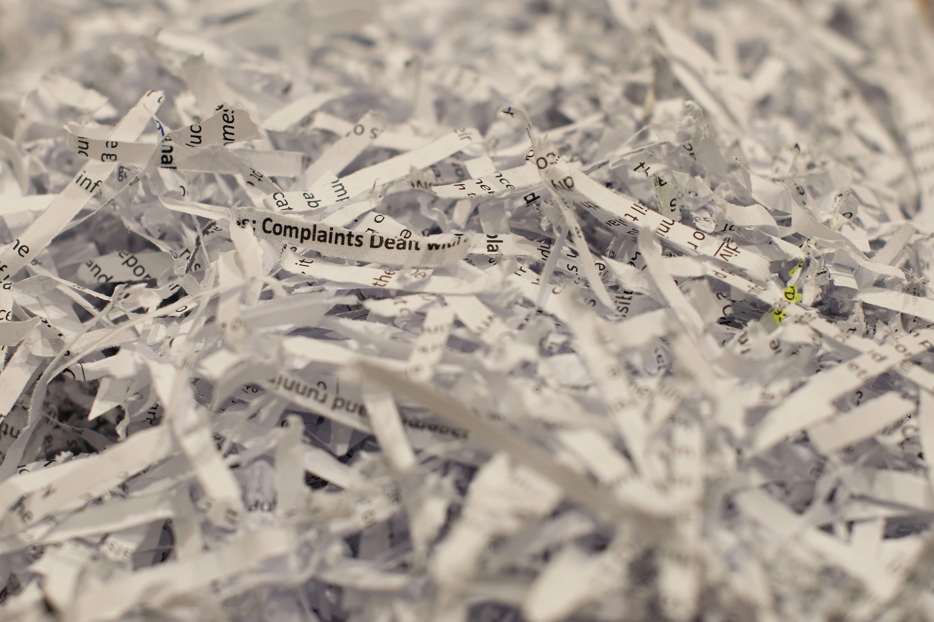 A pile of shredded paper representing the destruction or misappropriation of confidential information that often accompanies a senior employee's departure to a competitor