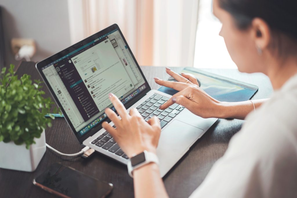 A person typing on a computer keyboard, representing the moment before publishing a public comment or review and the legal protections available under the fair comment defence in Canada