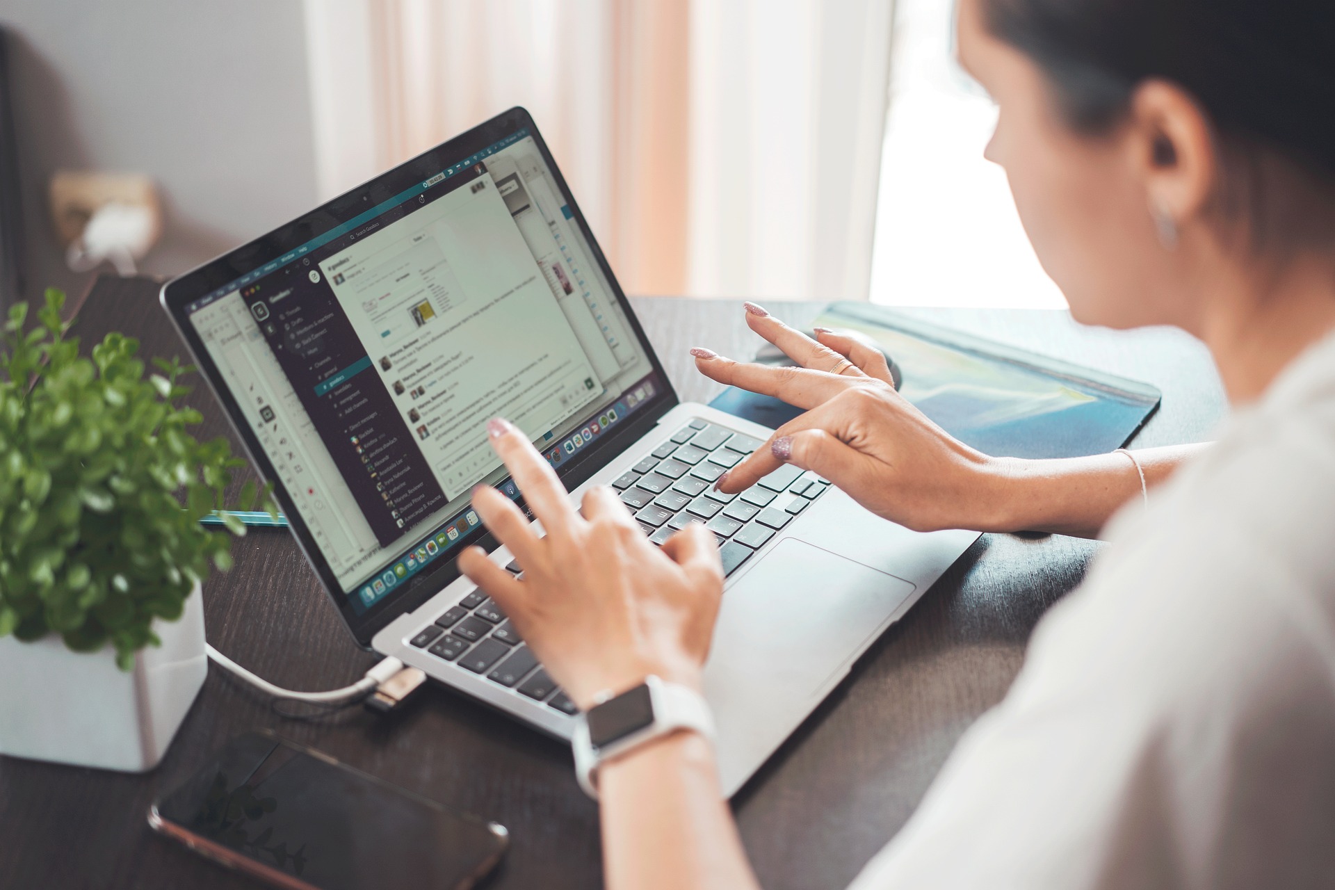 A person typing on a computer keyboard, representing the moment before publishing a public comment or review and the legal protections available under the fair comment defence in Canada
