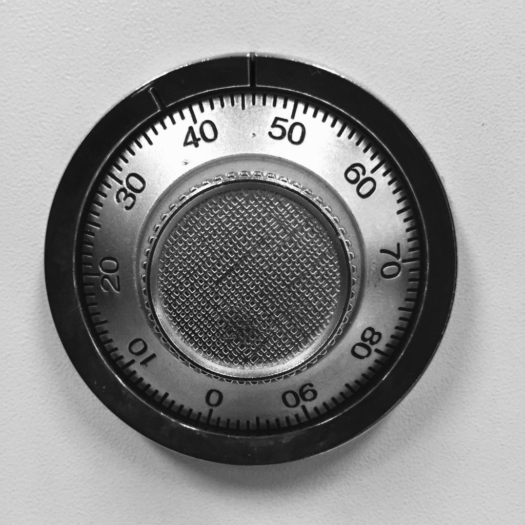 The numbered combination dial of a safe lock, photographed in black and white