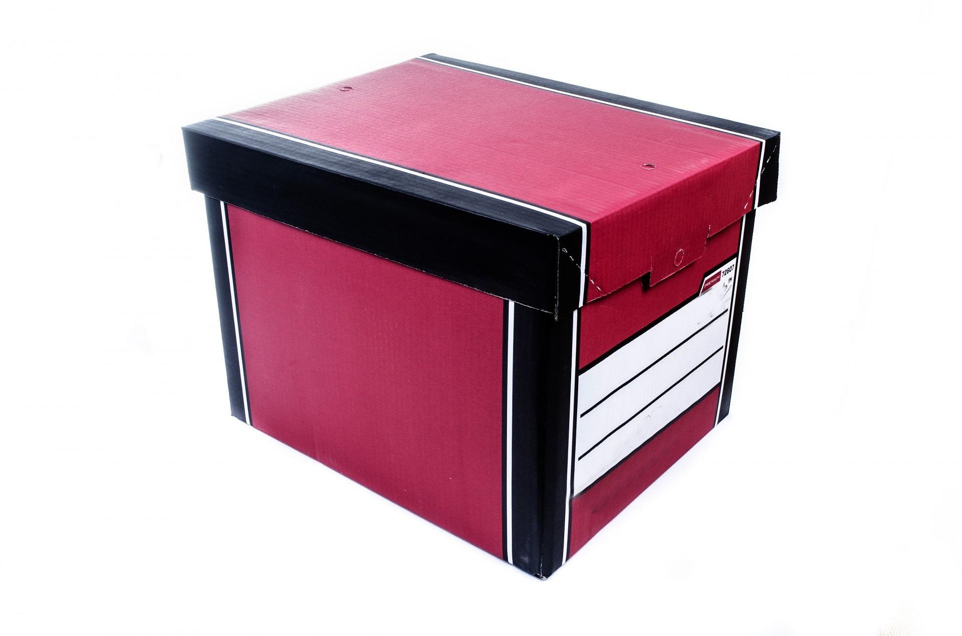 A red banker's box with a black lid and blank index labels, on a white background