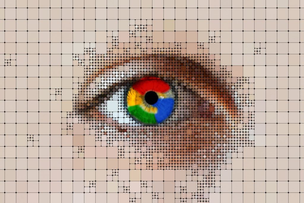 Close-up of an eye with a multicoloured iris over a grid of pixels